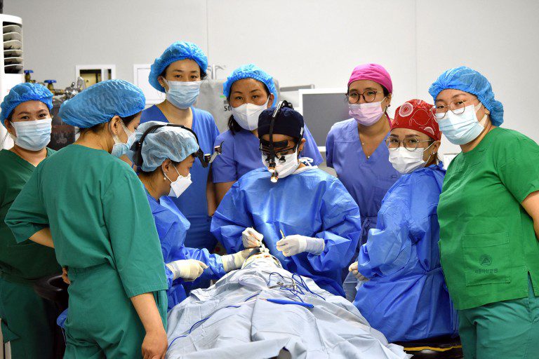 Medical staff hovered around a patient in the operating room